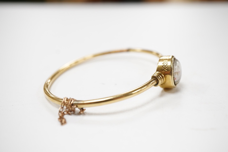 A regimental 'Essex Crystal' bangle, circa 1884, of hinged construction, collet-set with a reverse-carved and painted intaglio depicting the burgee of the Royal Yacht Squadron, mounted in gold, inscribed 'ER August 1884'